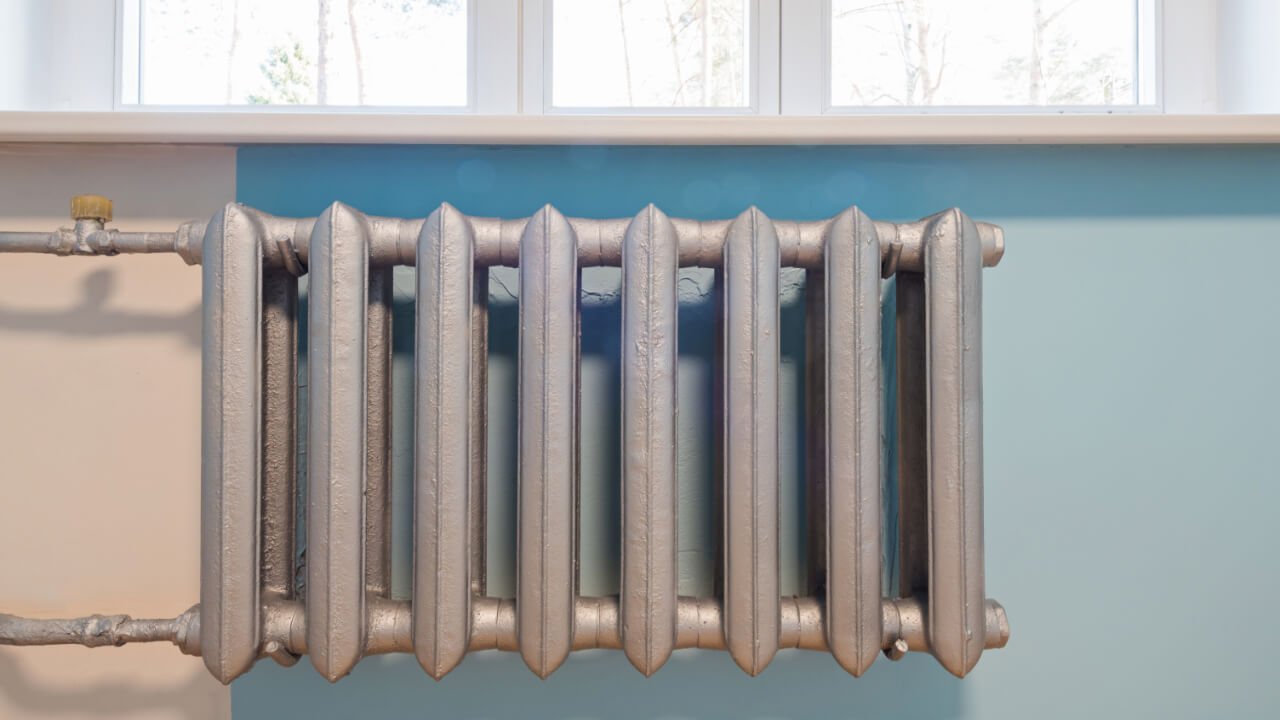 Classic silver radiator under a window